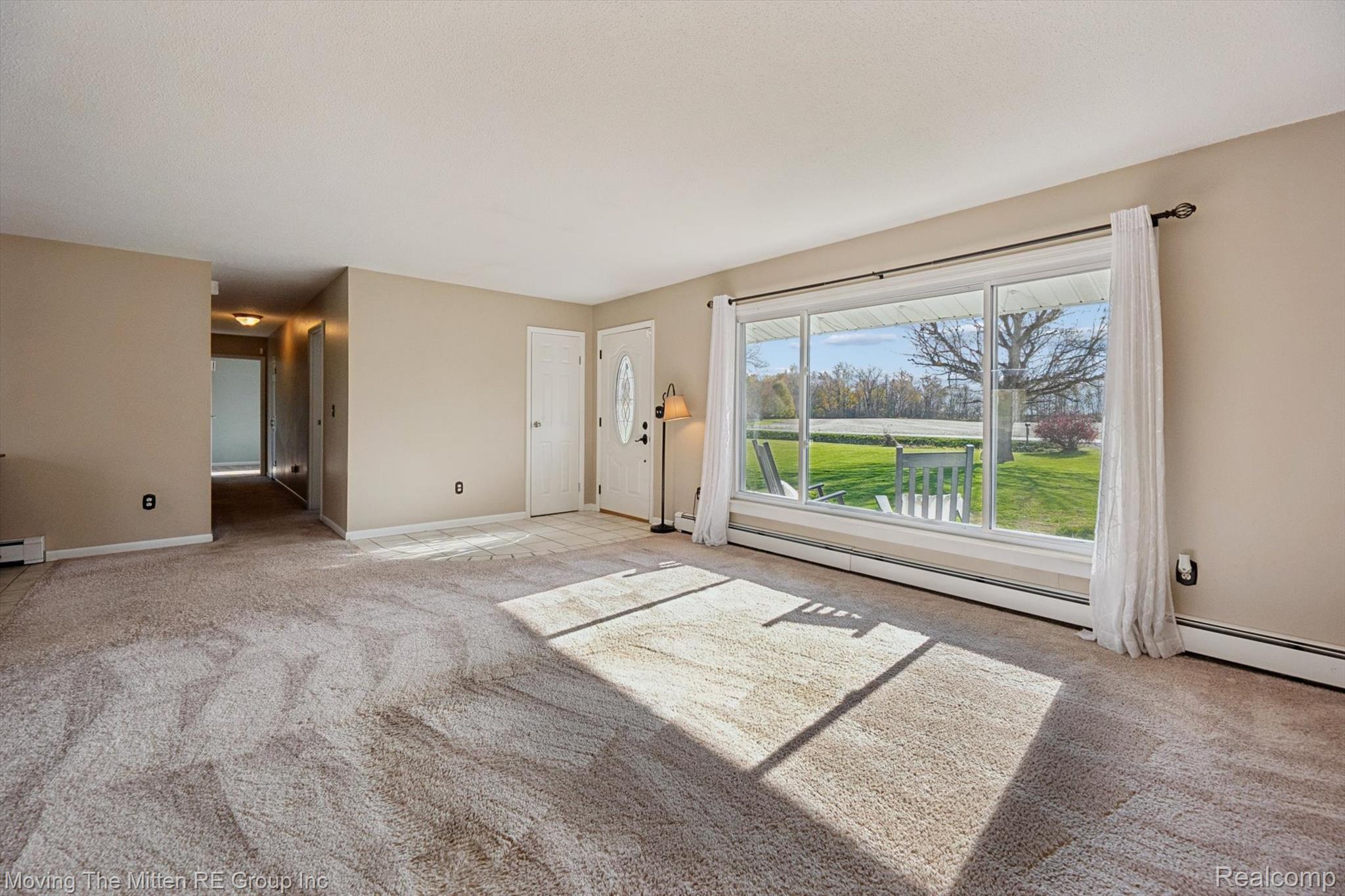 12000 Plank Road Milan, MI 48160 - Photo 6 of 49 Unfurnished living room with light carpet and baseboard heating