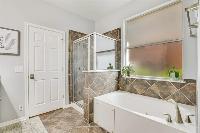 a bathroom with a bathtub and shower