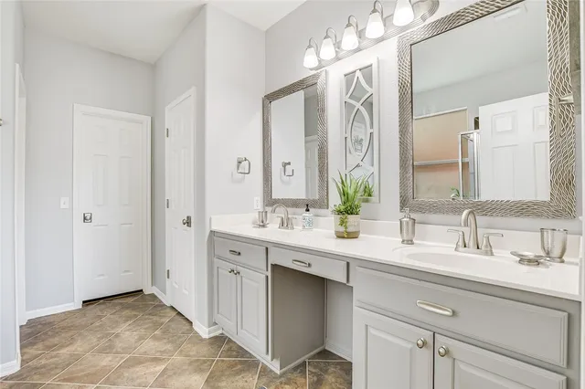 a bathroom with a double vanity sink mirror and