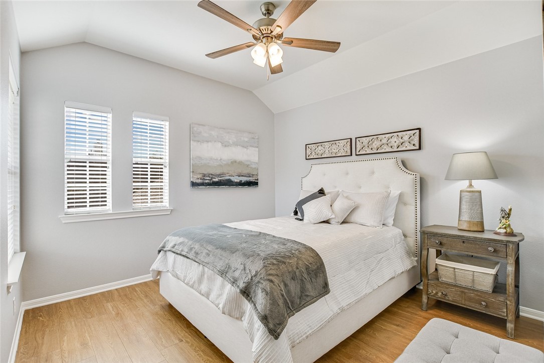 6405 York Bridge Circle Austin, TX 78749 - Photo 19 of 34 a bedroom with bed and a chandelier