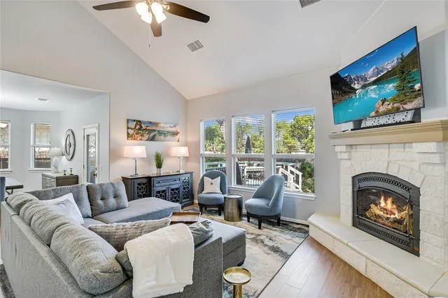 a living room with furniture a fireplace and a flat screen tv