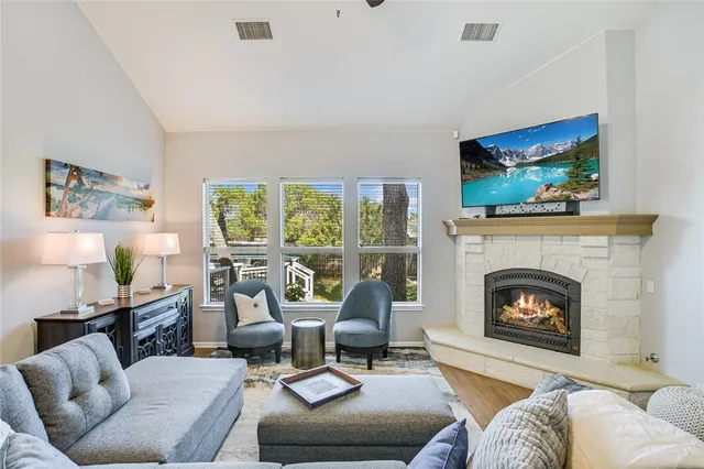 a living room with furniture fireplace and window