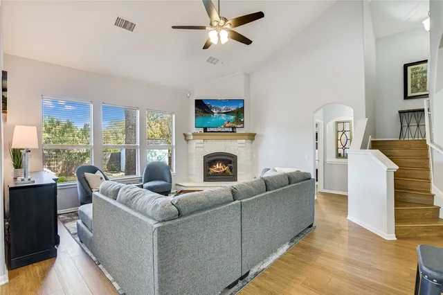 a living room with furniture a fireplace and a flat screen tv