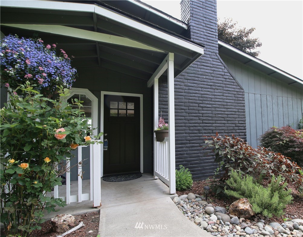 27615 Webster Road East Graham, WA 98338 - Photo 1 of 36 a front view of a house with a garden