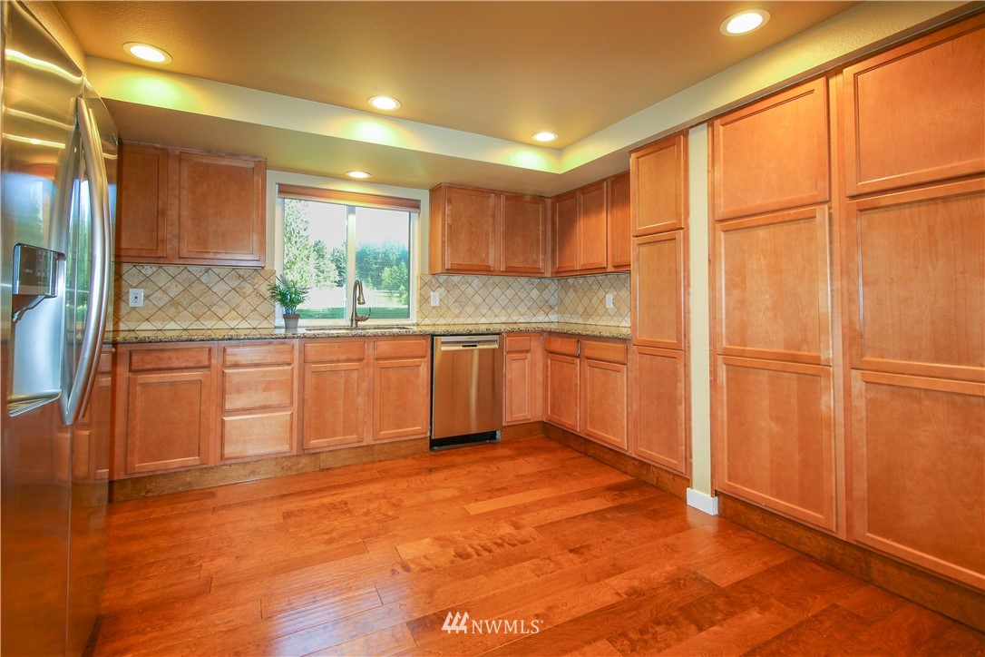 27615 Webster Road East Graham, WA 98338 - Photo 12 of 36 a view of a kitchen with a sink and a window