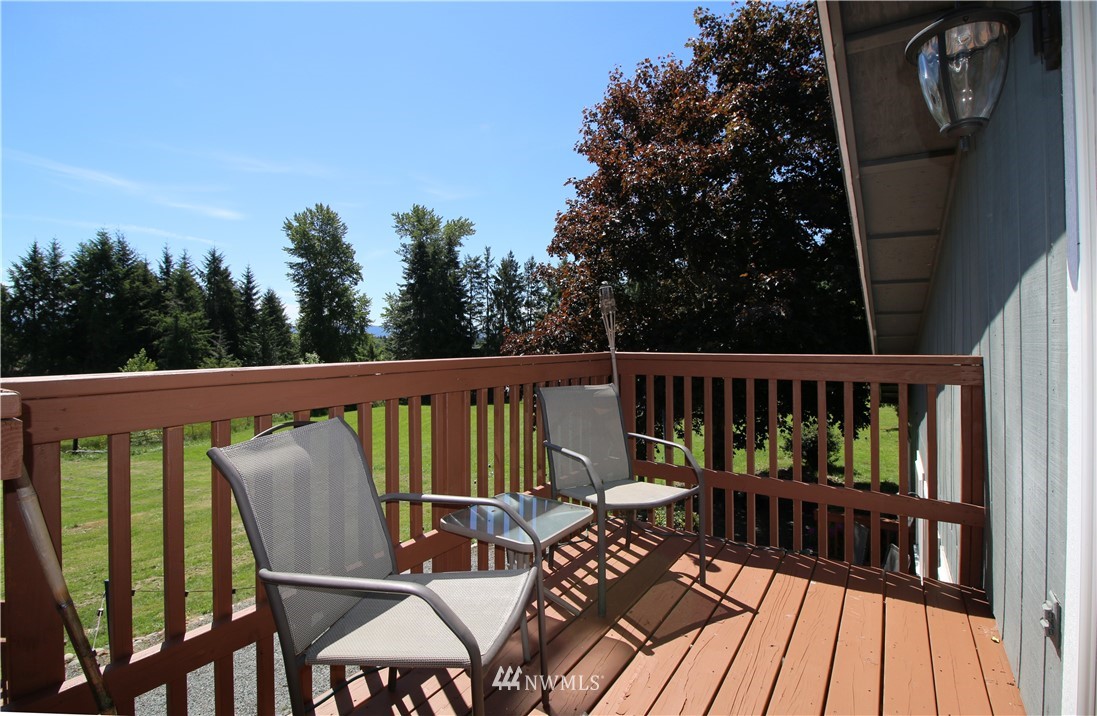 27615 Webster Road East Graham, WA 98338 - Photo 16 of 36 a view of a balcony with furniture