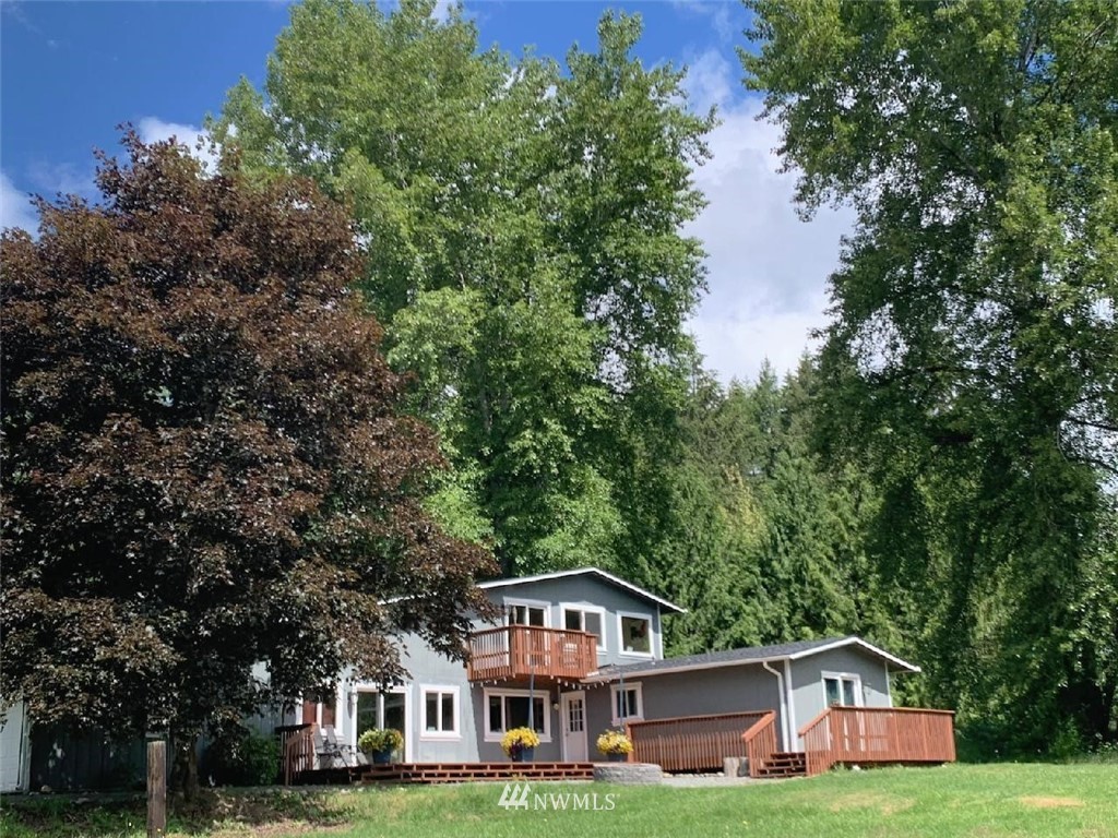 27615 Webster Road East Graham, WA 98338 - Photo 3 of 36 a front view of a house with a yard and large trees
