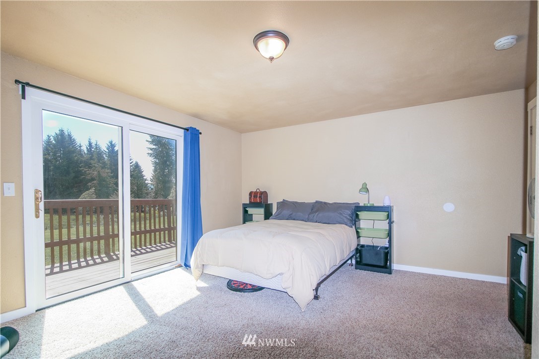 27615 Webster Road East Graham, WA 98338 - Photo 25 of 36 a bedroom with a bed and a large window