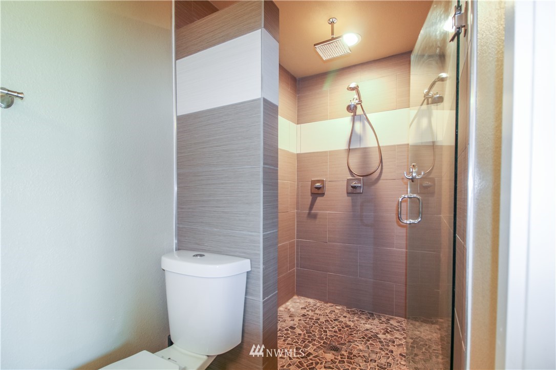 27615 Webster Road East Graham, WA 98338 - Photo 27 of 36 a bathroom with a shower