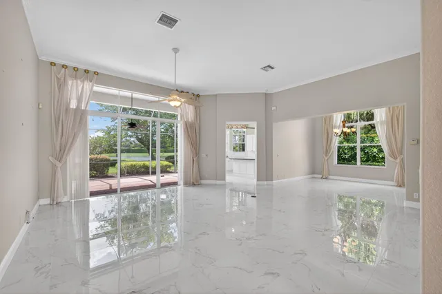 a view of a room with wooden floor and chandelier