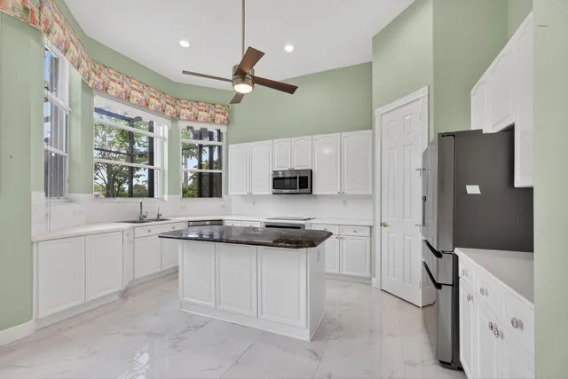 a kitchen with stainless steel appliances granite countertop a stove and a sink