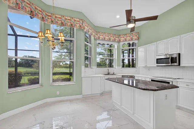 a kitchen with stainless steel appliances granite countertop a refrigerator sink and cabinets