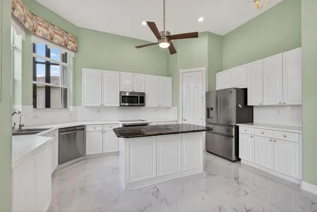 a kitchen with granite countertop a sink and stove