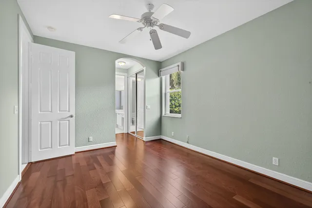 a spacious bathroom with a granite countertop sink a mirror and a