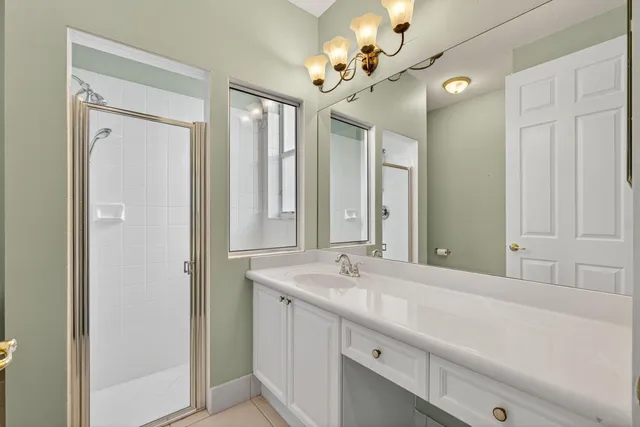 a room with pool table and chandelier