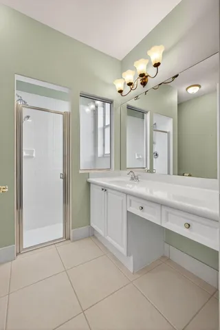 a bathroom with a sink a mirror and a shower