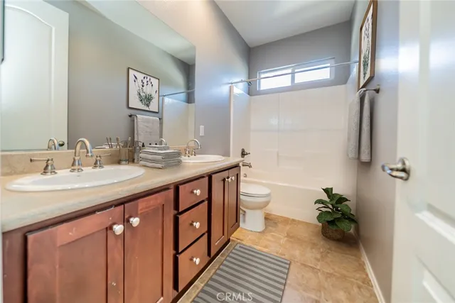 a spacious bathroom with a double vanity sink and a mirror