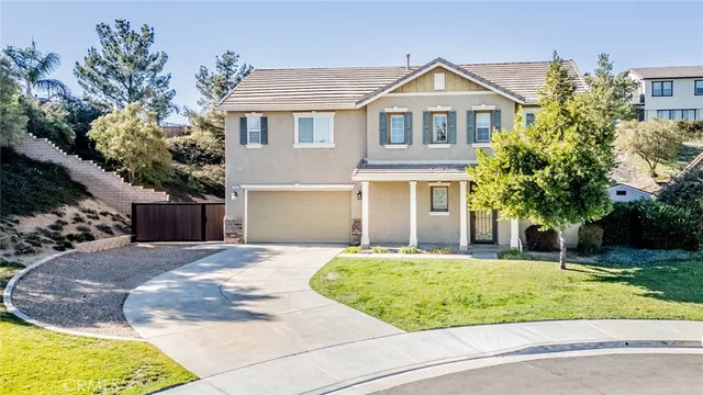 a front view of a house with a yard and trees