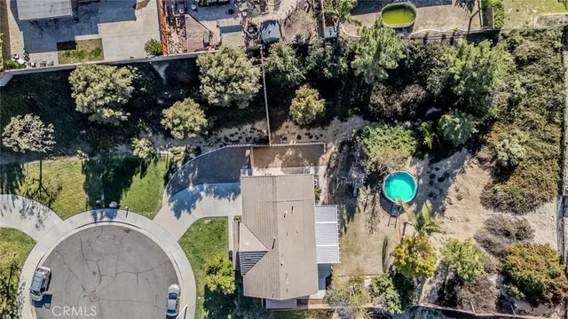 an aerial view of a house with a swimming pool