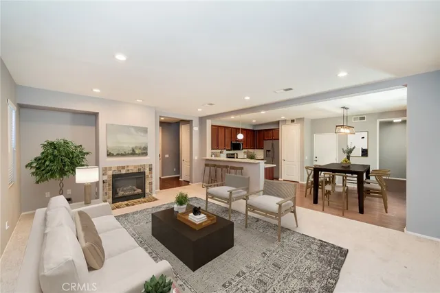 a living room with furniture a fireplace a flat screen tv and a fireplace