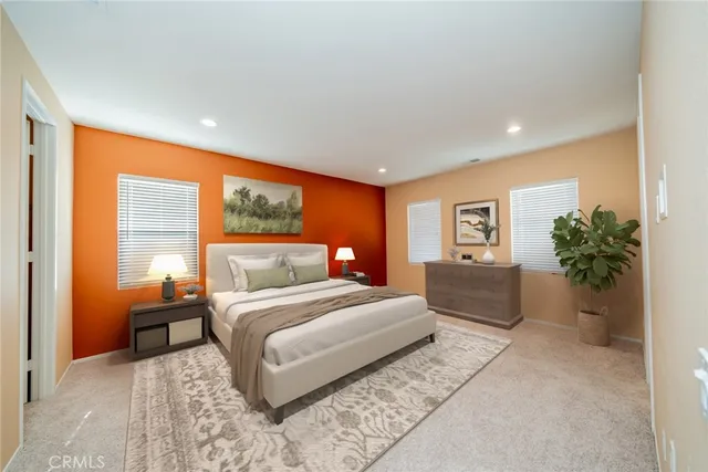 a bedroom with a large bed and a potted plant