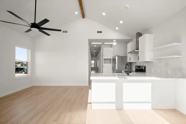 a view of a kitchen with a sink and a refrigerator