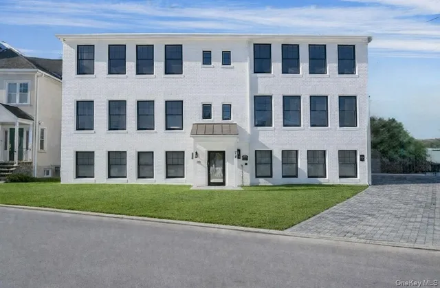 a front view of a building with a yard