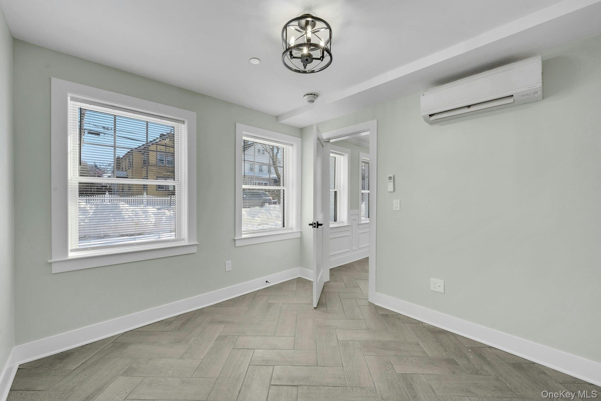 74 Nelson Avenue, Unit 1 Harrison, NY 10528 - Photo 12 of 15 an empty room with windows and closet