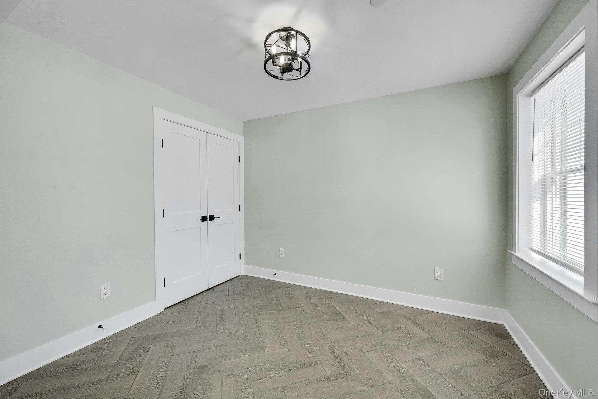 74 Nelson Avenue, Unit 1 Harrison, NY 10528 - Photo 15 of 15 an empty room with windows