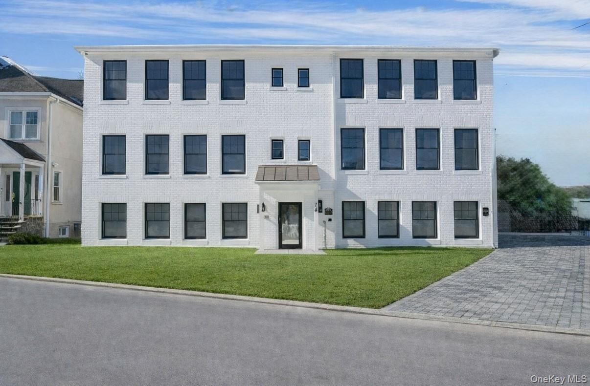 74 Nelson Avenue, Unit 1 Harrison, NY 10528 - Photo 4 of 15 a front view of a building with a yard