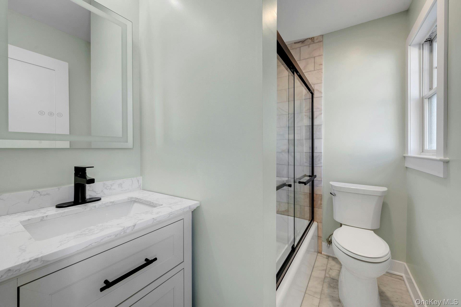 74 Nelson Avenue, Unit 1 Harrison, NY 10528 - Photo 7 of 15 a bathroom with a sink a toilet and shower