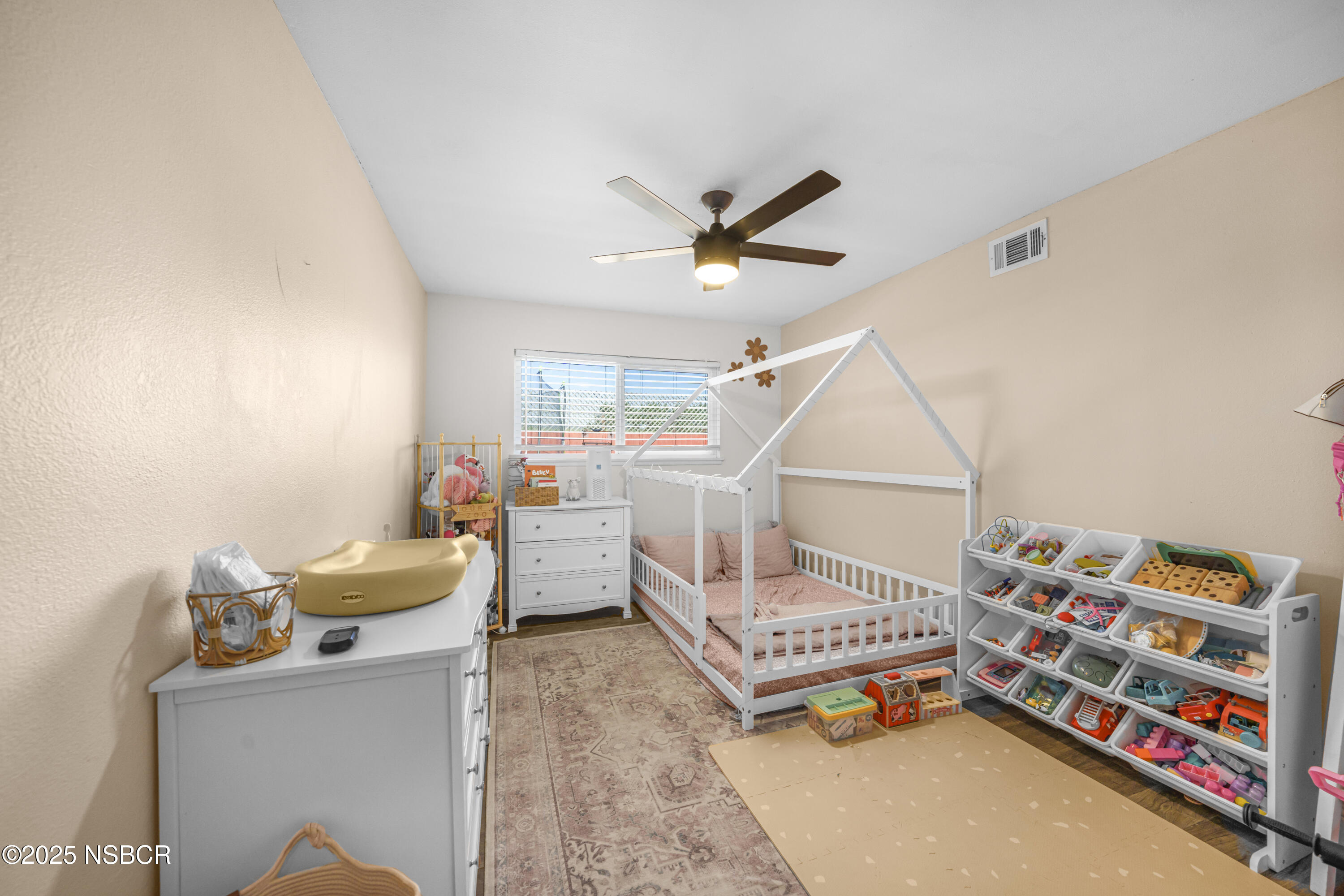 3939 Saturn Avenue Lompoc, CA 93436 - Photo 14 of 26 a bedroom with furniture and a wooden floor