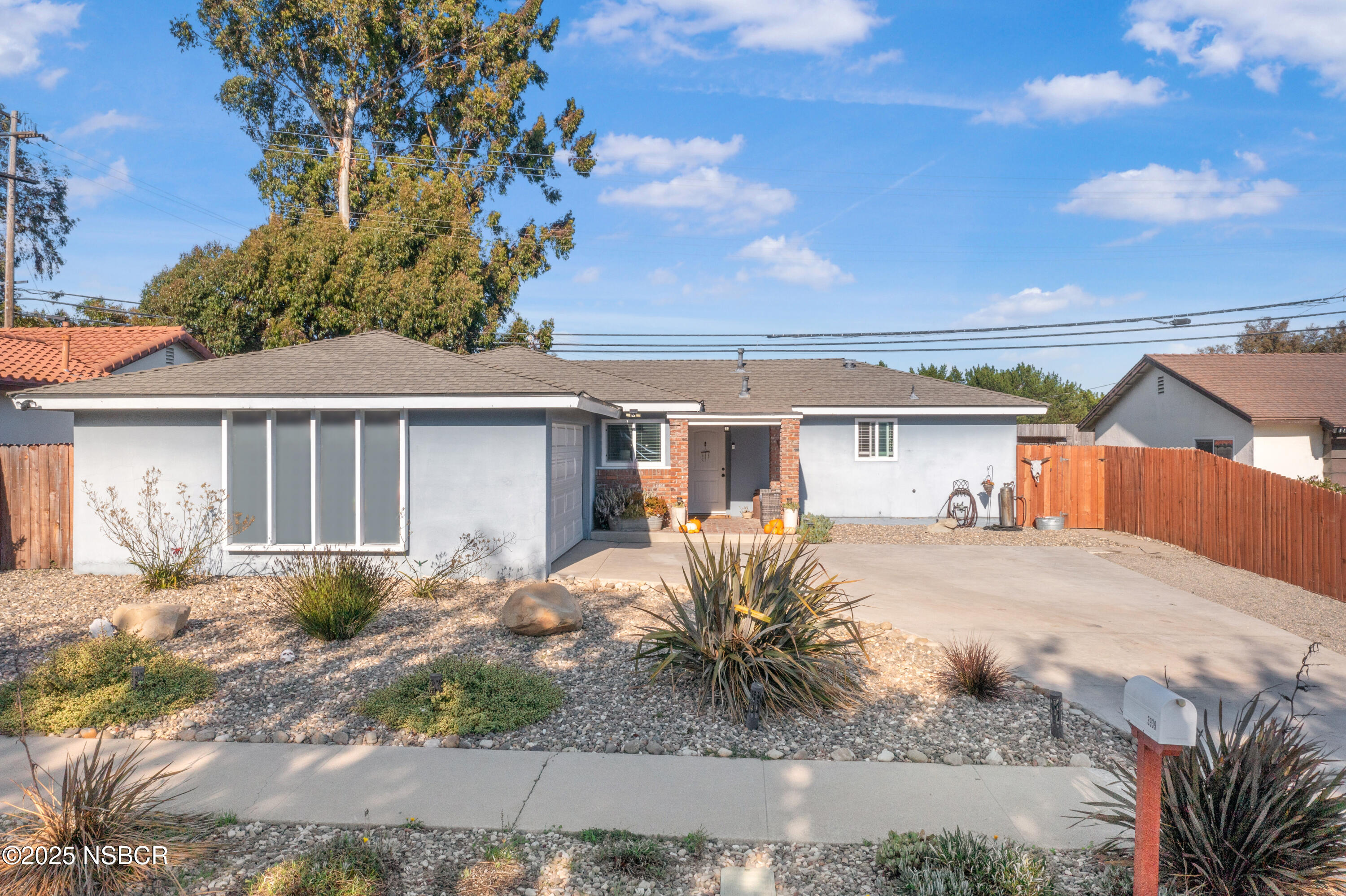 3939 Saturn Avenue Lompoc, CA 93436 - Photo 2 of 26 a front view of a house with garden