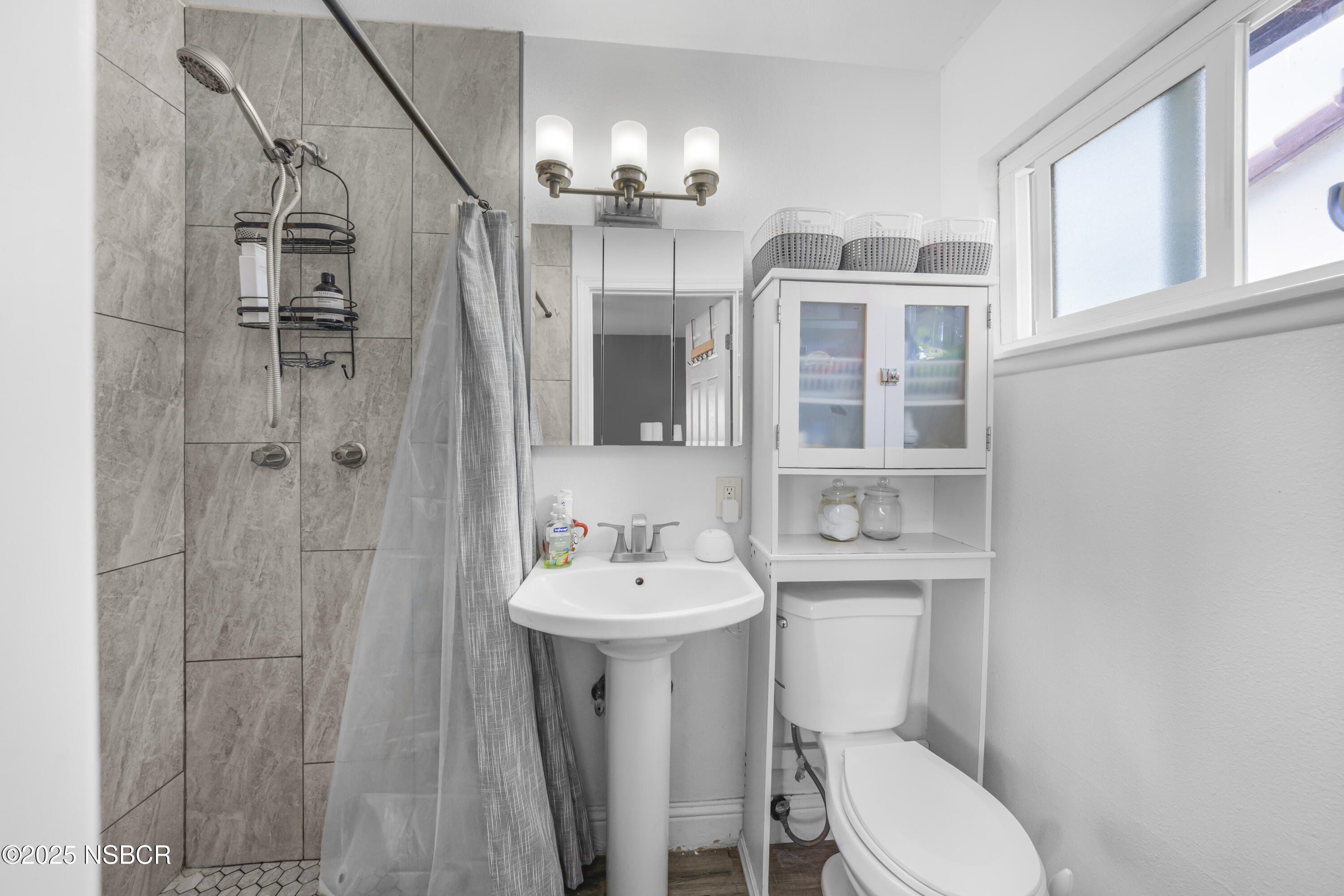 3939 Saturn Avenue Lompoc, CA 93436 - Photo 23 of 26 a bathroom with a sink toilet and shower