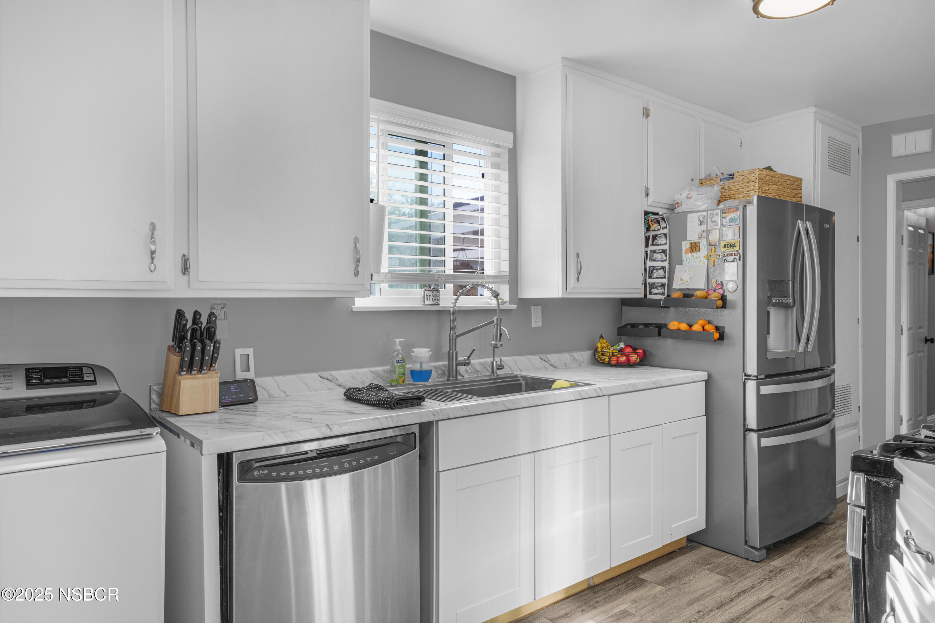 3939 Saturn Avenue Lompoc, CA 93436 - Photo 9 of 26 a kitchen with refrigerator a stove a sink and a cabinets
