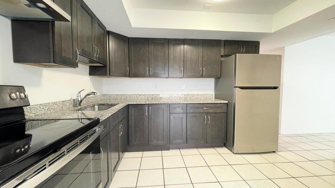 4606 Southeast Binnacle Way, Unit 6 Stuart, FL 34997 - Photo 1 of 6 a kitchen with a sink and a refrigerator