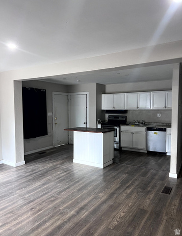 3161 Adams Avenue Ogden, UT 84403 - Photo 4 of 17 Open-concept living area featuring wood-finish flooring, recessed lighting, and a white kitchen island with a dark countertop