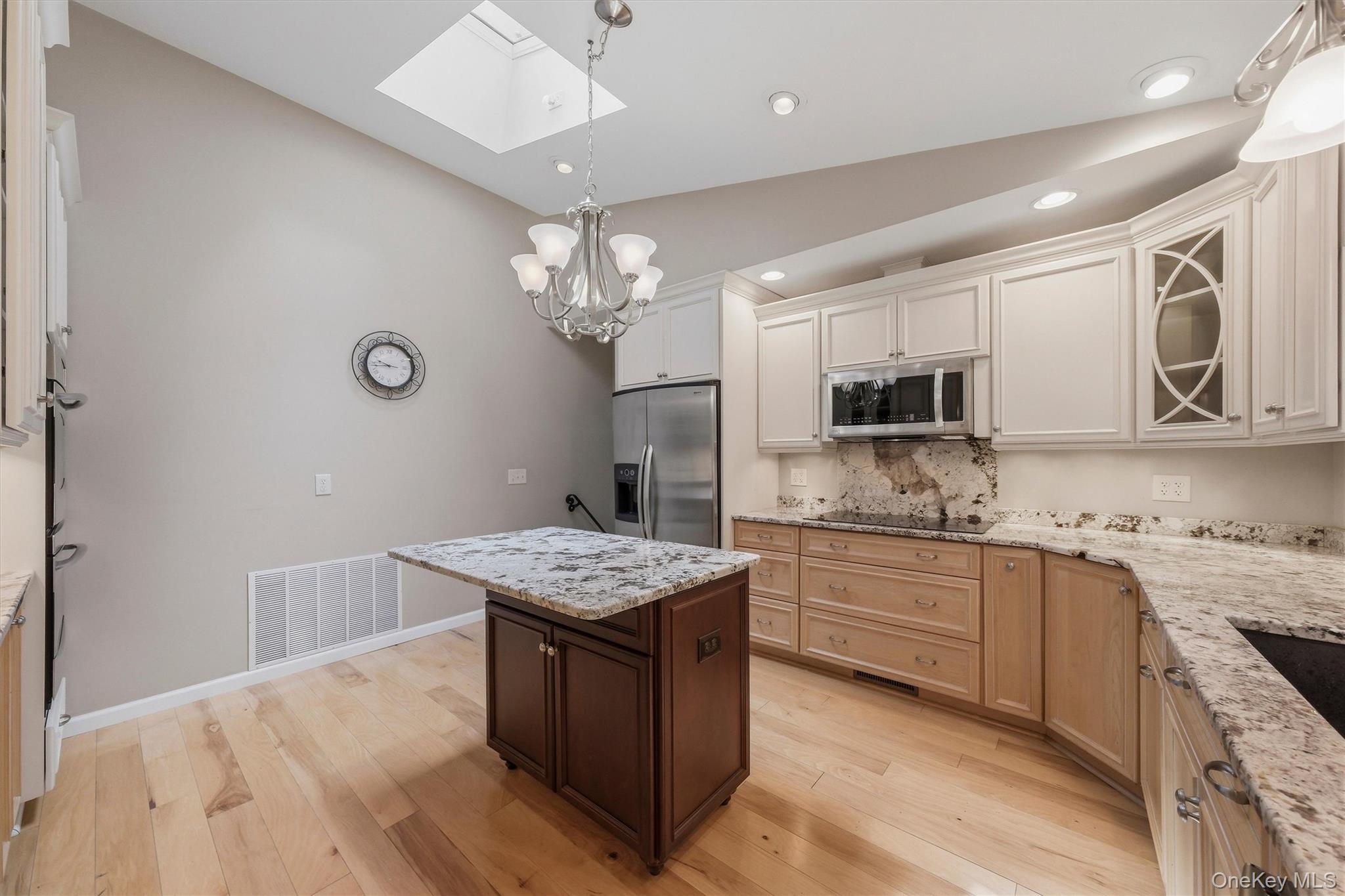 75 Pleasant Ridge Drive Poughkeepsie, NY 12603 - Photo 13 of 47 Custom kitchen with center island and snack bar, stainless appliances including double ovens, granite counters and wood floors