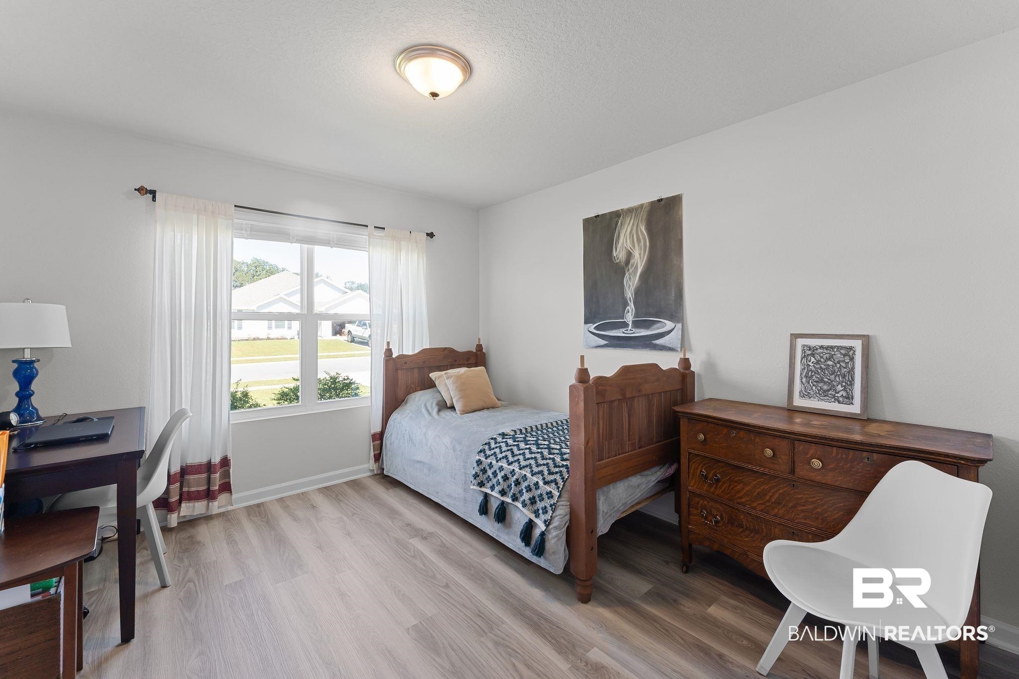 24337 Ringneck Loop Elberta, AL 36530 - Photo 23 of 34 Bedroom featuring light wood finished floors and a textured ceiling