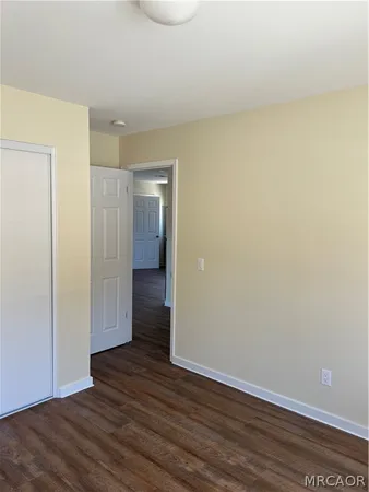 a view of an empty room and wooden floor