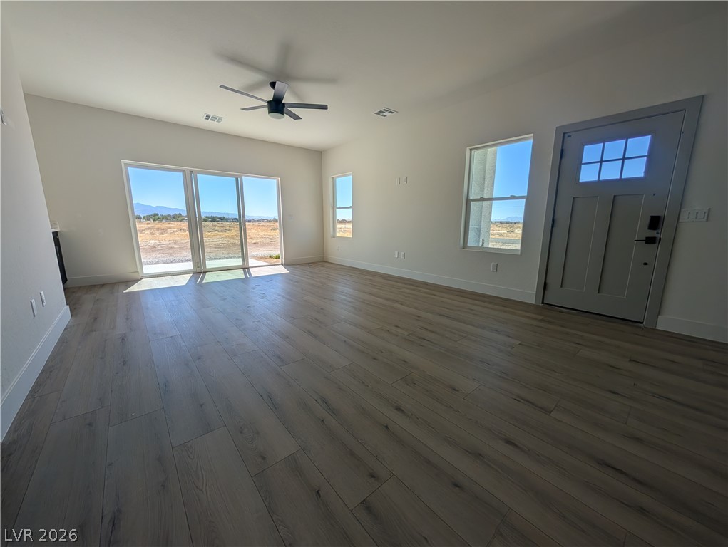 4670 Medicine Man Road Pahrump, NV 89048 - Photo 12 of 36 Vast natural light illuminates the inviting interior, highlighting the gorgeous flooring and spacious layout.
