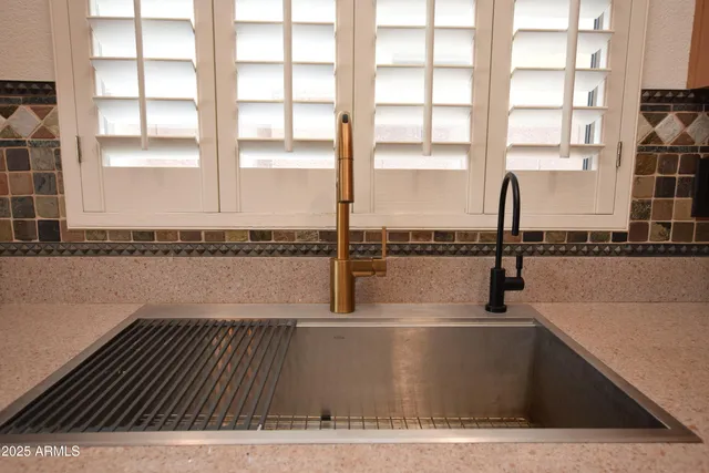 a large kitchen with a table and chairs