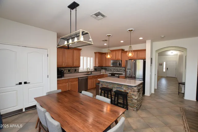 a front view of a house with garden and sitting area