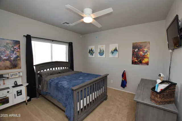 a bedroom with a bed and a window