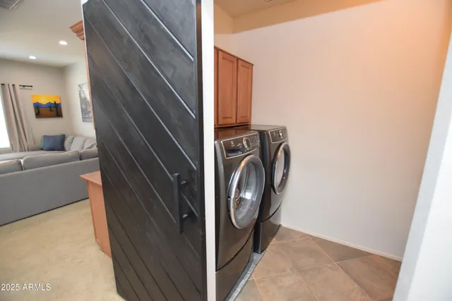 a view of storage and utility room with washer and dryer