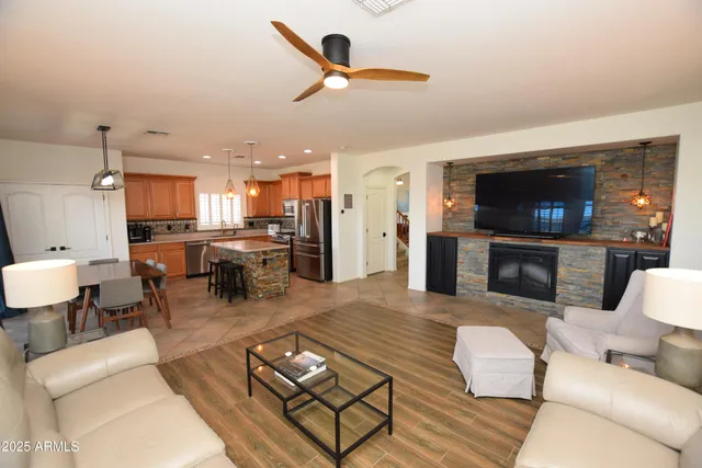 a living room with furniture kitchen view and a fireplace