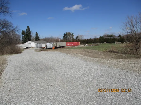 a terrace with a bench and trees