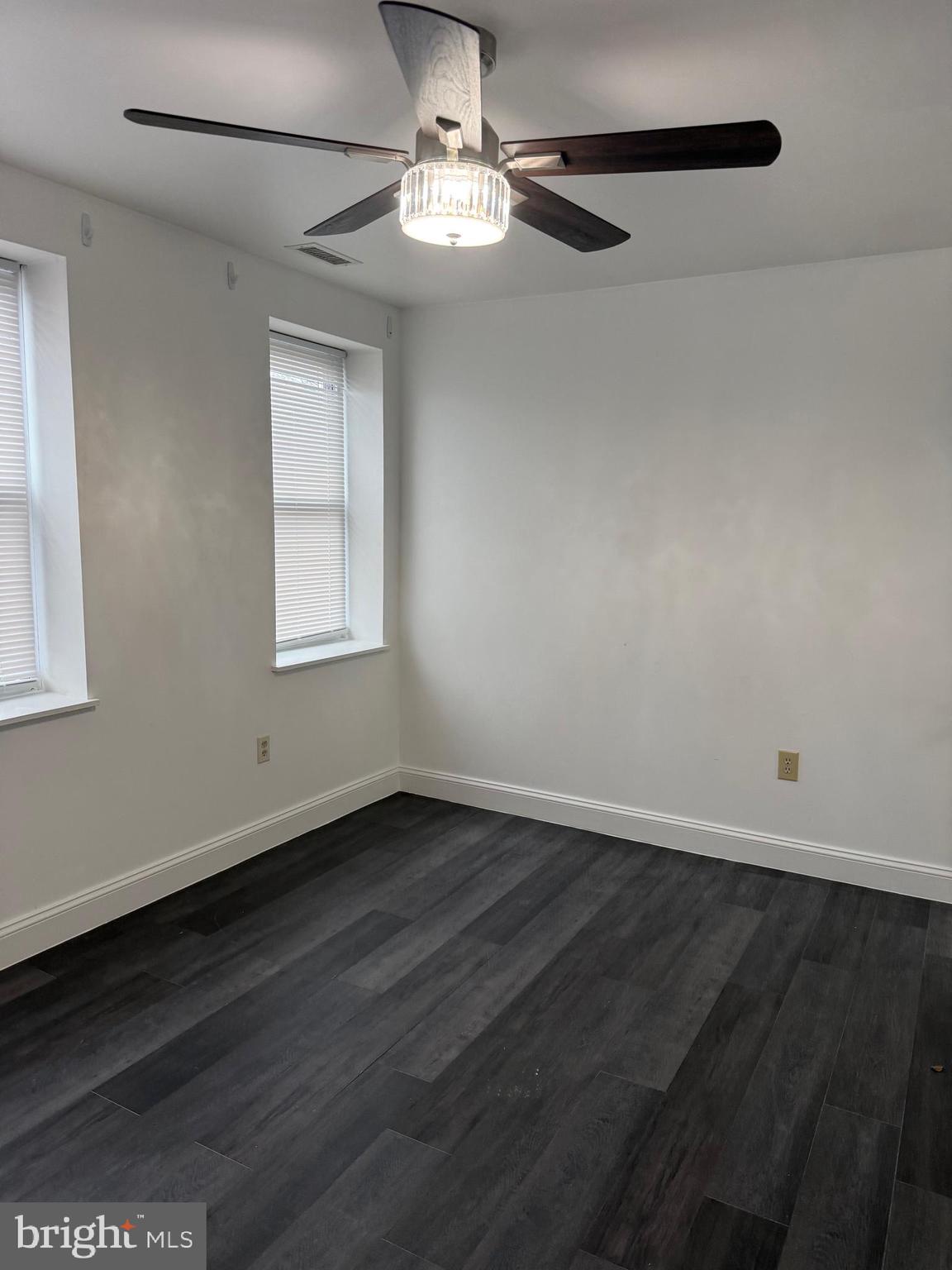 2511 Maryland Avenue, Unit 3 Baltimore, MD 21218 - Photo 7 of 11 a view of an empty room with wooden floor and a window