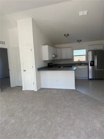 a view of a kitchen with a sink and cabinets