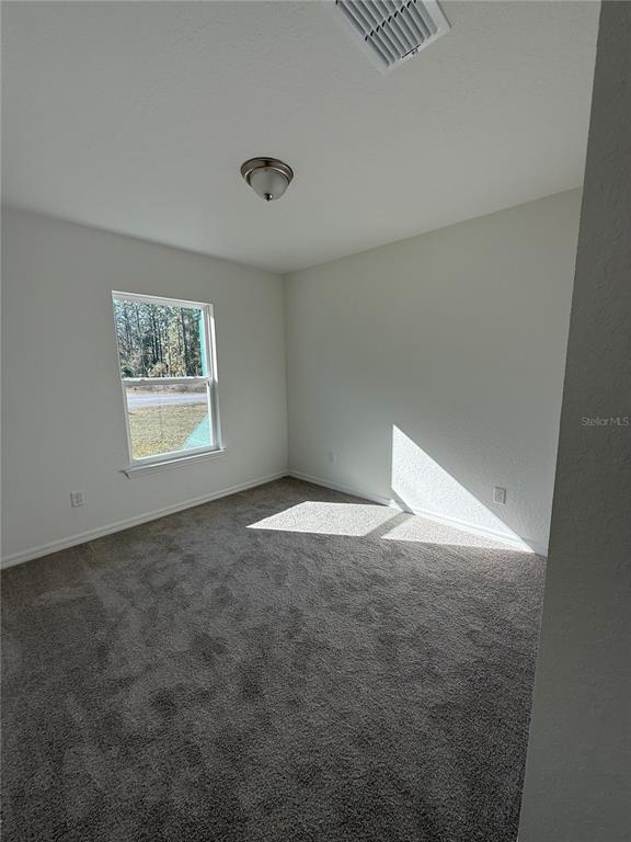 24449 Falcon Avenue Dunnellon, FL 34431 - Photo 8 of 11 an empty room with windows